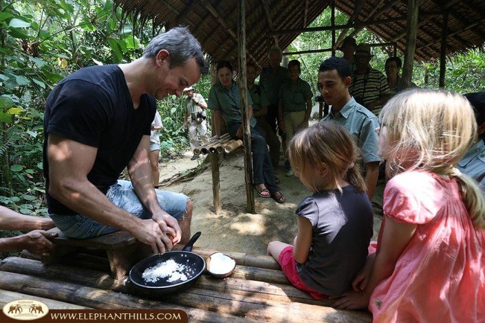 Grating fresh coconuts to prepare a fresh coconut milk for Tom Kha Gai in the Elephant Hills jungle kitchen