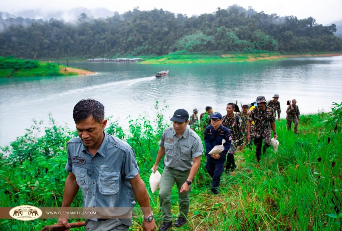 Elephant Hills staff and park rangers carrying equipment at Cheow Larn lake